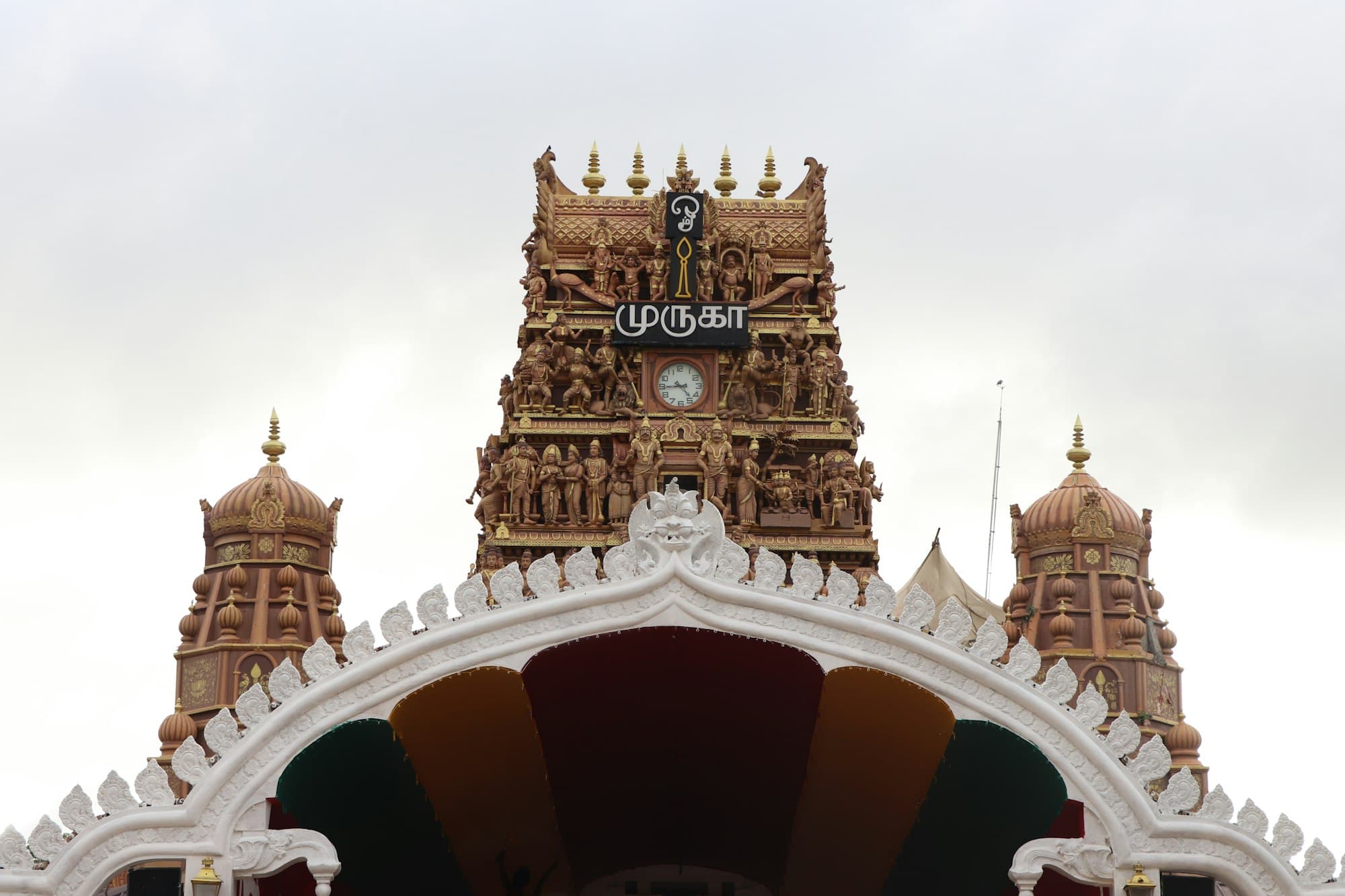The Nallur Kandaswamy Kovil gopuram in Jaffna, Sri Lanka — Tamil-Hindu architecture in carved gold and ochre